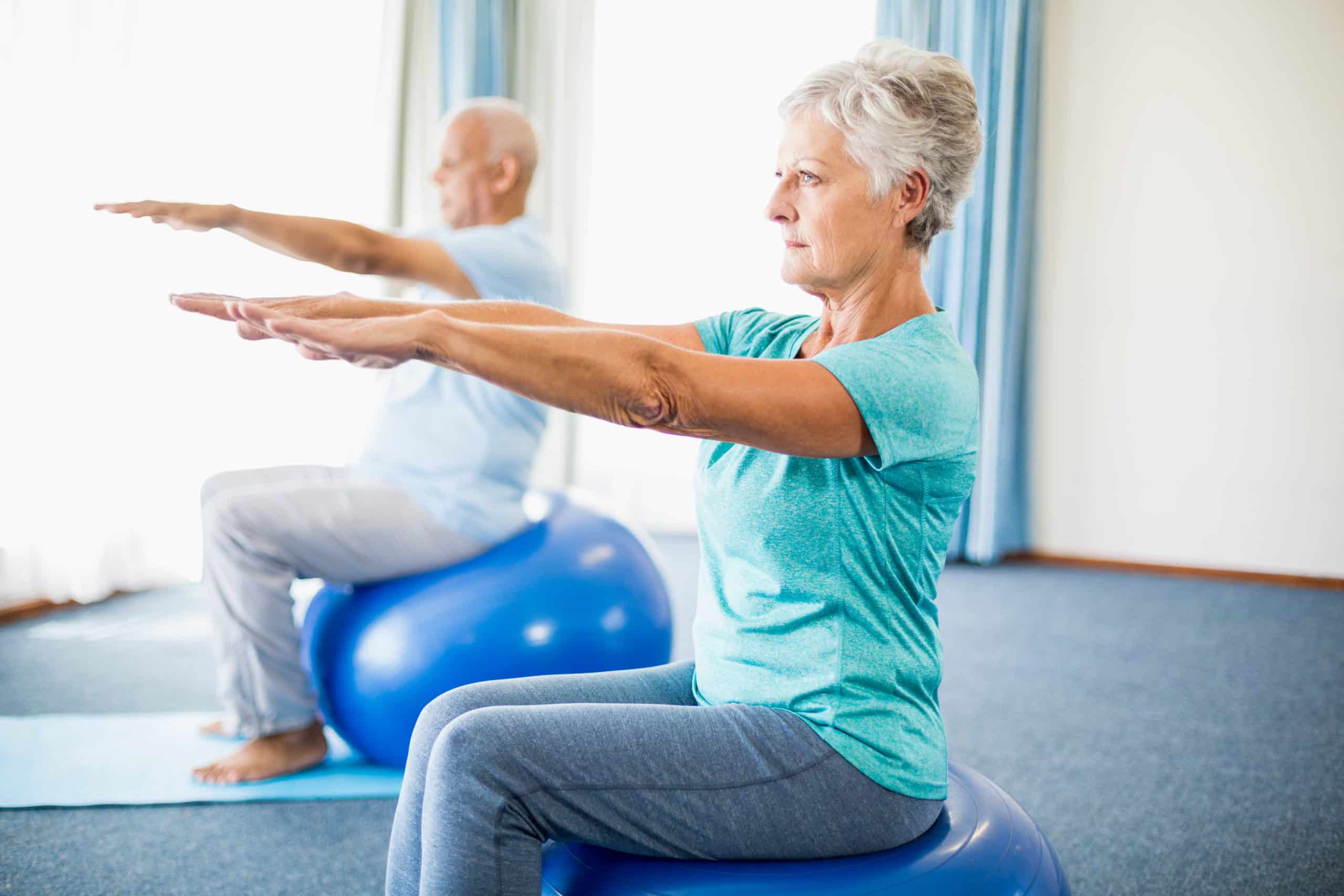 Older adults doing seated balance exercises on stability balls during vestibular rehabilitation