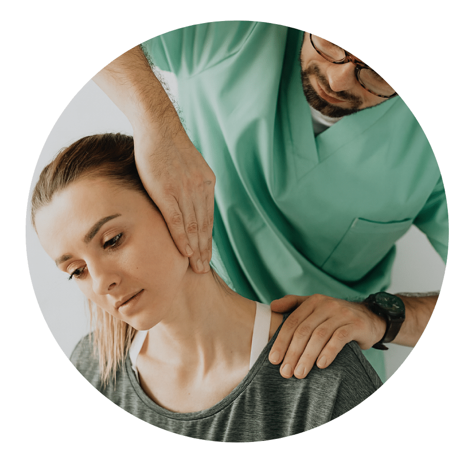 Physical therapist stretching a woman's neck while steadying her shoulder