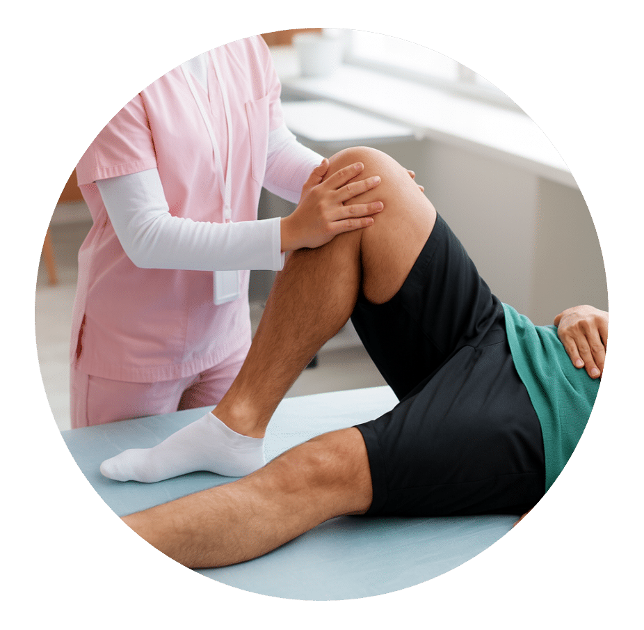 Clinician holding a patient's bent knee to move the hip on a treatment table