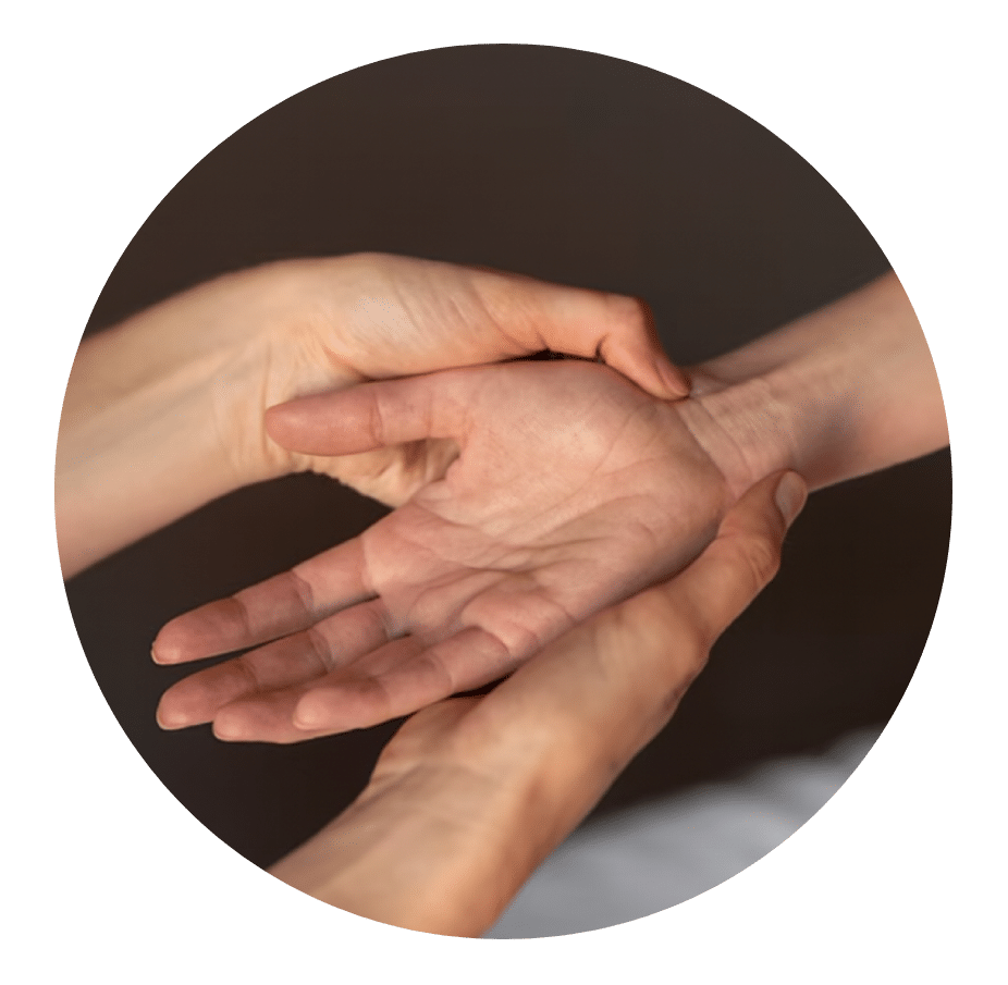 Physical therapist supporting a patient's open hand and wrist