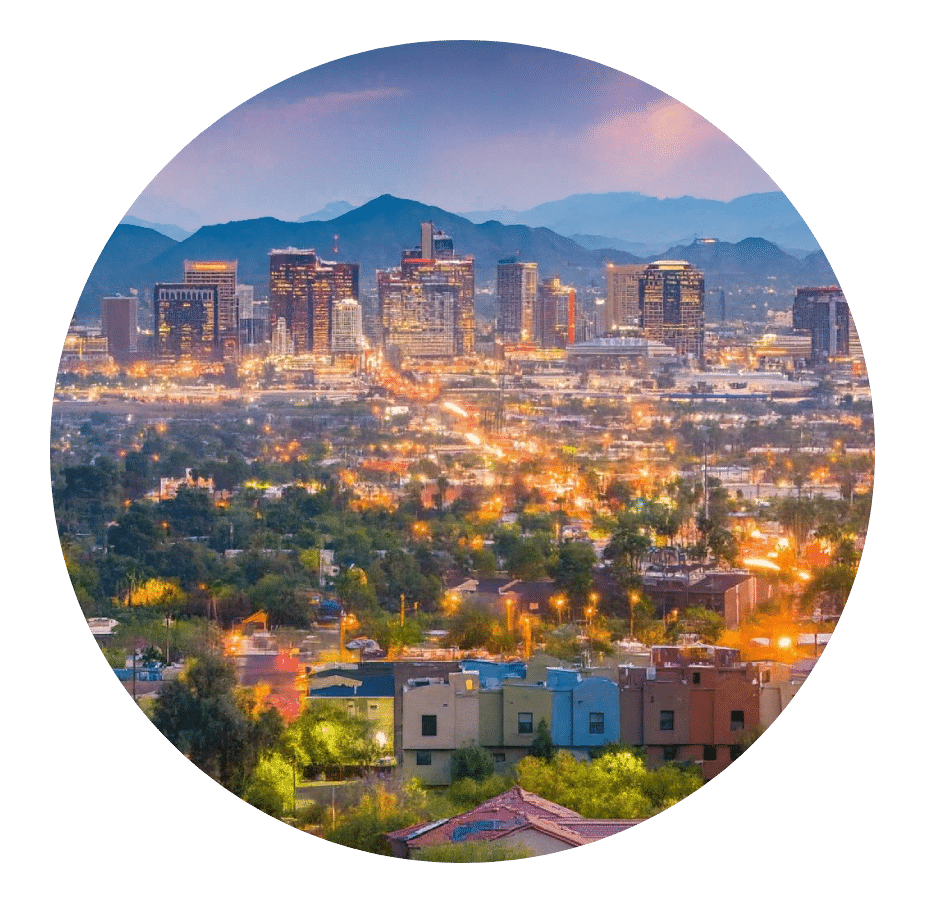 Downtown Phoenix skyline lit up at dusk with mountains behind