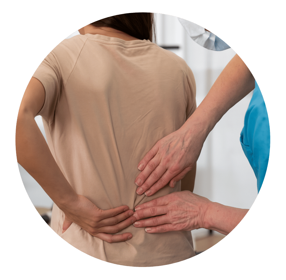 Clinician pressing on a woman's lower back as she holds it in pain
