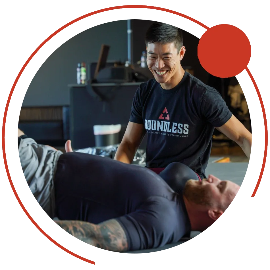 Dr. Phil Yoon working with a client on the mat