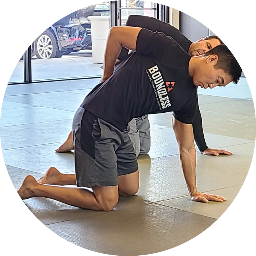 Dr. Phil Yoon coaching a client through a mobility exercise
