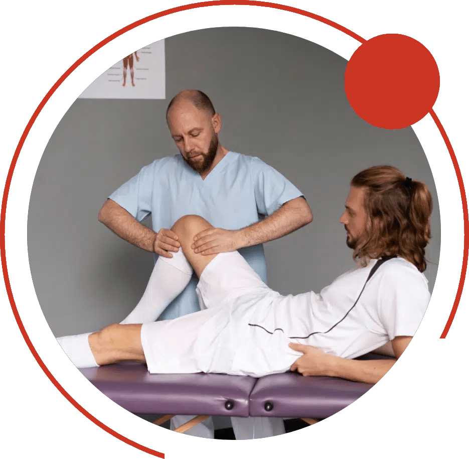 Physical therapist mobilizing a patient's bent knee on a treatment table