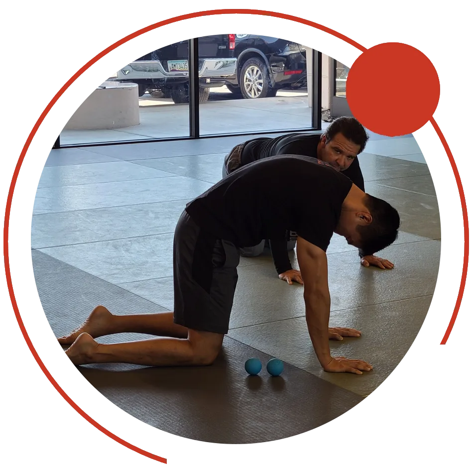 Dr. Phil Yoon coaching a client through a mid-back mobility drill